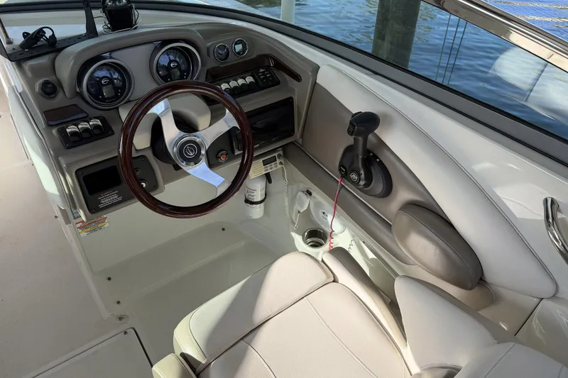 Slide: The Image of 2013 Crownline 285 SS boat cockpit with steering wheel and control panel. - 4