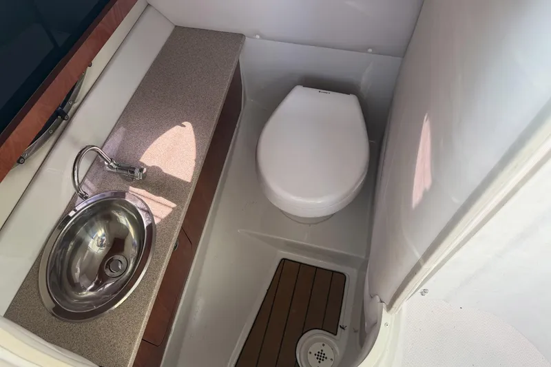 Slide: The Image of 2013 Crownline 285 SS boat bathroom with sink and toilet. - 6