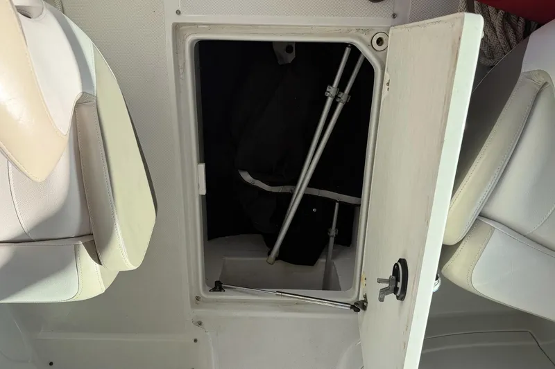 Slide: The Image of Open storage compartment on a 2013 Crownline 285 SS boat, showing interior details. - 7