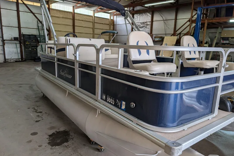 Slide: The Image of 2016 SunChaser Oasis Fish 816 pontoon boat in a warehouse setting. - 12
