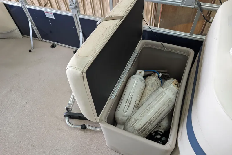 Slide: The Image of Storage compartment on a 2016 SunChaser Oasis Fish 816 boat with fenders inside. - 7