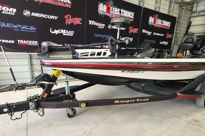 Slide: The Image of 2013 Ranger Z518 Comanche boat on trailer in showroom with branded backdrop. - 3