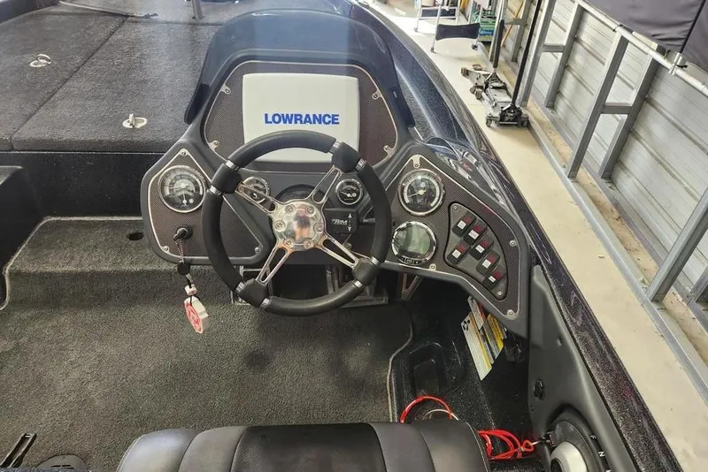 Slide: The Image of 2013 Ranger Z518 Comanche boat dashboard with Lowrance electronics and steering wheel. - 4