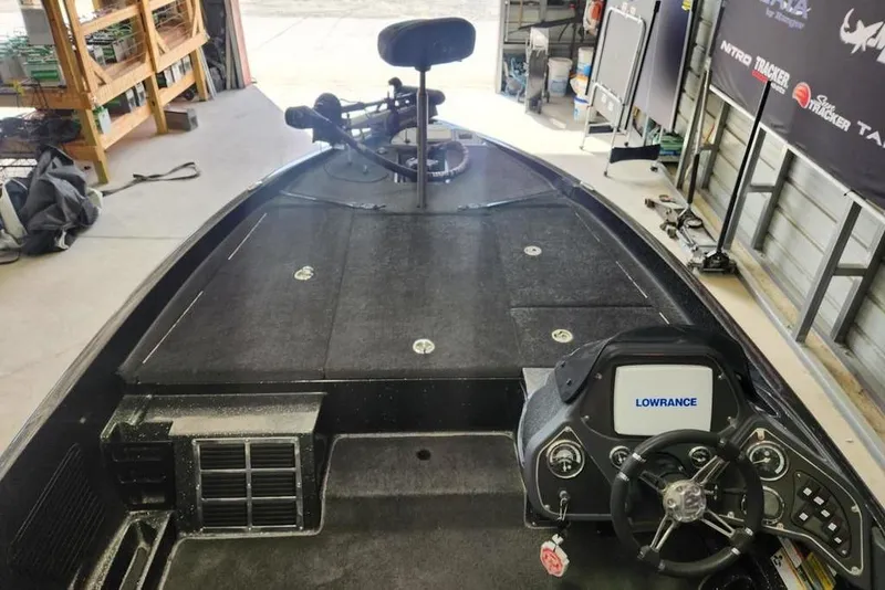Slide: The Image of 2013 Ranger Z518 Comanche boat interior with Lowrance electronics in a garage setting. - 9