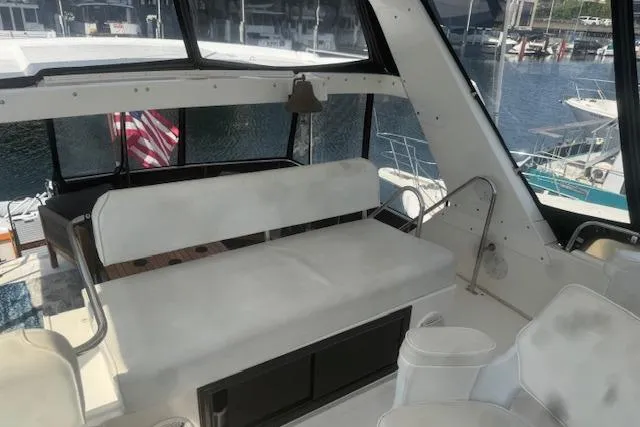 Slide: The Image of 1993 Ocean Alexander 440 Sundeck CPMY interior with seating, overlooking marina. - 10