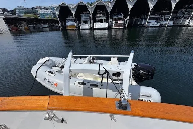 Slide: The Image of 1993 Ocean Alexander 440 Sundeck CPMY with dinghy docked at marina. - 12