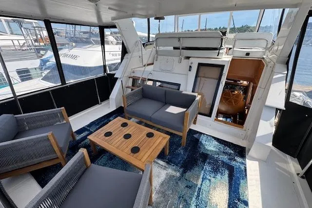 Slide: The Image of Spacious 1993 Ocean Alexander 440 Sundeck CPMY yacht interior with modern seating and nautical decor. - 15