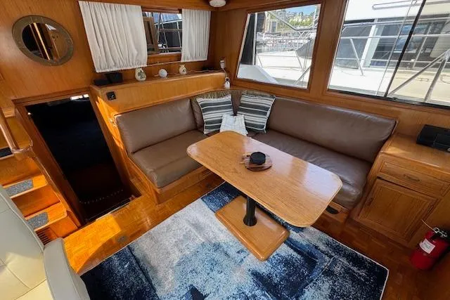 Slide: The Image of Interior of 1993 Ocean Alexander 440 Sundeck CPMY with cozy seating and wooden table. - 16