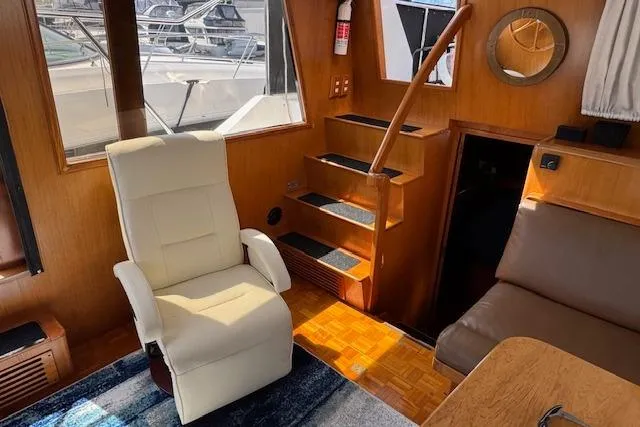Slide: The Image of Interior of 1993 Ocean Alexander 440 Sundeck CPMY with seating and wooden stairs. - 17