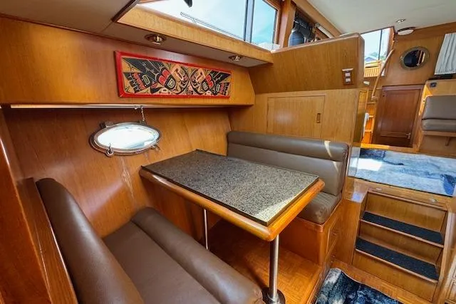 Slide: The Image of Interior of 1993 Ocean Alexander 440 Sundeck CPMY with cozy dining area and wooden finishes. - 20