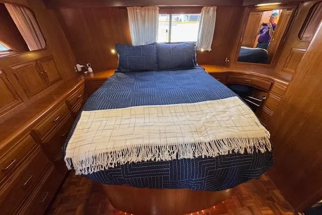 Slide: The Image of Cozy bedroom in 1993 Ocean Alexander 440 Sundeck CPMY with wooden interior and blue bedding. - 24