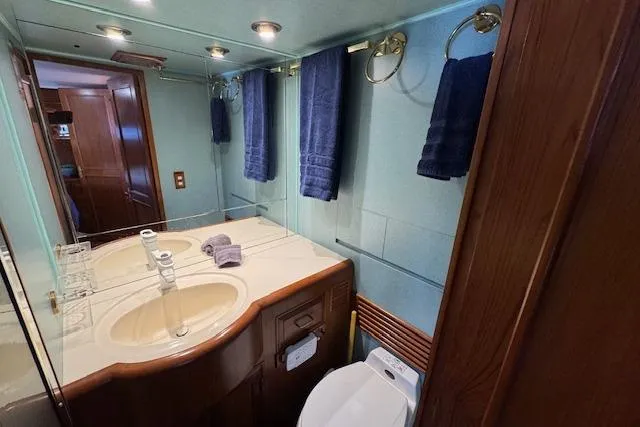 Slide: The Image of Luxurious bathroom in 1993 Ocean Alexander 440 Sundeck CPMY yacht with dual sinks and elegant wood accents. - 27
