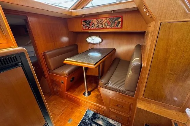 Slide: The Image of 1993 Ocean Alexander 440 Sundeck CPMY interior with cozy dining area and wooden finishes. - 29