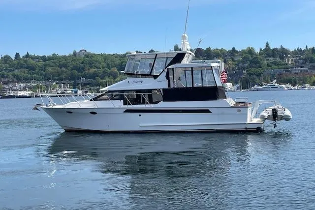 Slide: The Image of 1993 Ocean Alexander 440 Sundeck CPMY yacht on calm water, scenic background. - 4