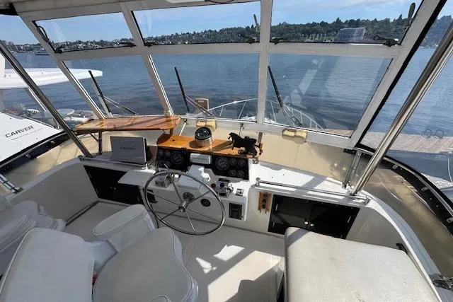 Slide: The Image of Cockpit view of 1993 Ocean Alexander 440 Sundeck CPMY, featuring helm and waterfront scenery. - 6