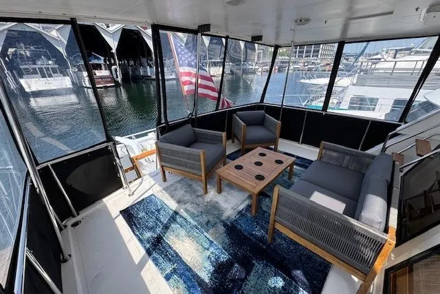 Slide: The Image of 1993 Ocean Alexander 440 Sundeck CPMY yacht with elegant seating and marina view. - 9