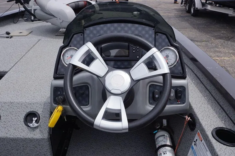Slide: The Image of 2023 G3 Sportsman 1710 boat dashboard with steering wheel and gauges. - 3
