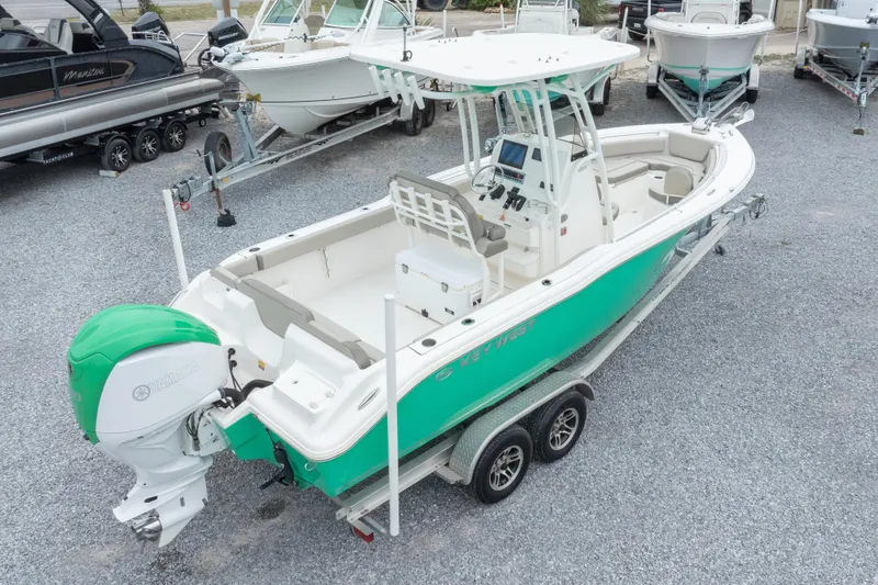 Slide: The Image of 2023 Key West 239 FS boat on trailer, featuring a vibrant green hull and Yamaha outboard motor. - 10