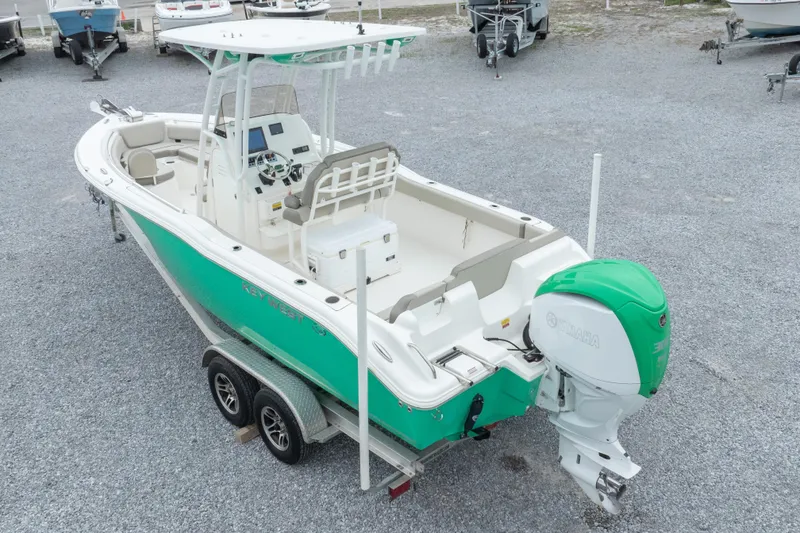 Slide: The Image of 2023 Key West 239 FS boat with Yamaha engine on trailer, parked on gravel. - 11