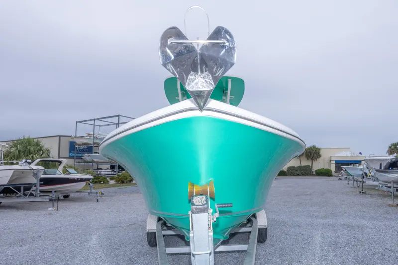 Slide: The Image of 2023 Key West 239 FS boat on trailer, vibrant teal hull, displayed outdoors. - 18