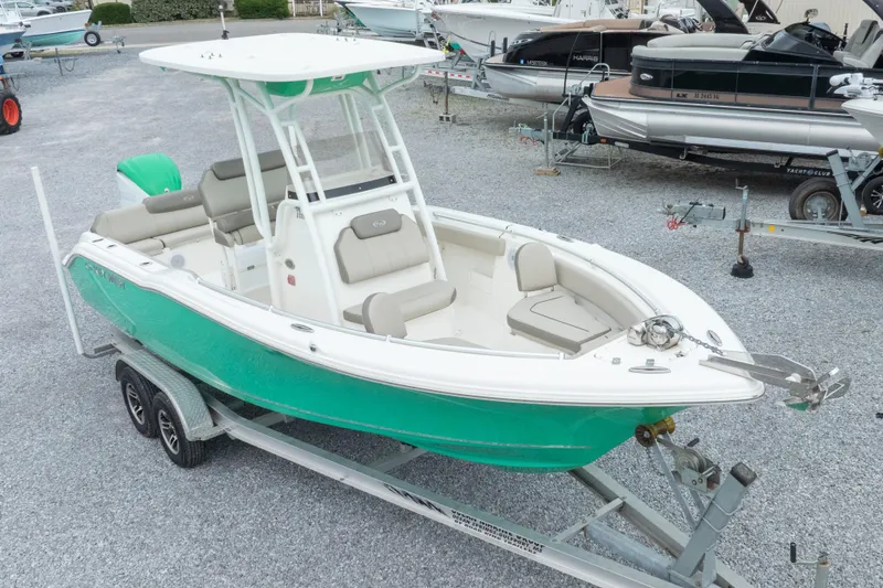 Slide: The Image of 2023 Key West 239 FS boat on trailer, vibrant green hull, spacious seating, ready for adventure. - 2