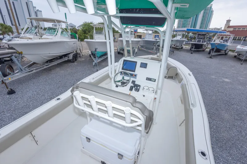 Slide: The Image of 2023 Key West 239 FS boat interior with modern dashboard and seating. - 21