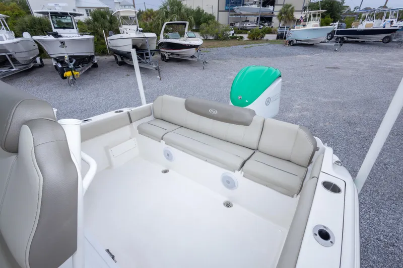 Slide: The Image of 2023 Key West 239 FS boat interior with cushioned seating and outboard motor. - 23