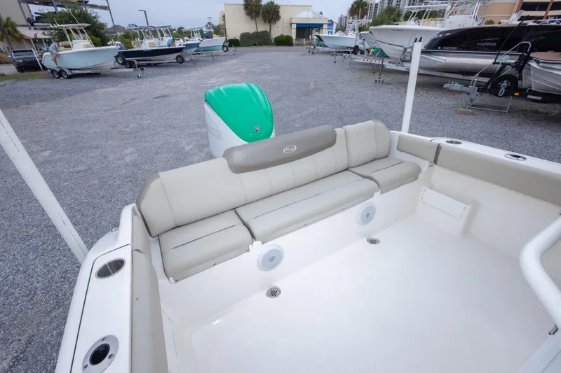 Slide: The Image of 2023 Key West 239 FS boat interior with cushioned seating and outboard motor. - 24