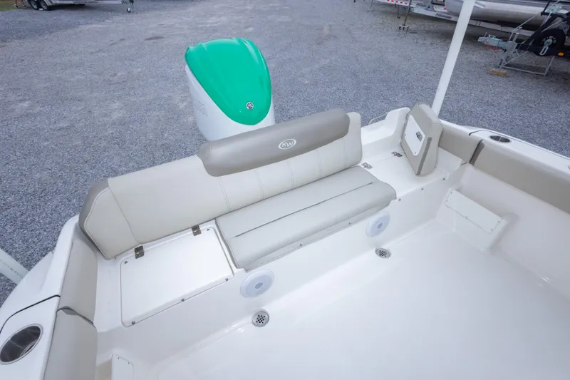 Slide: The Image of 2023 Key West 239 FS boat interior with seating and green motor. - 26