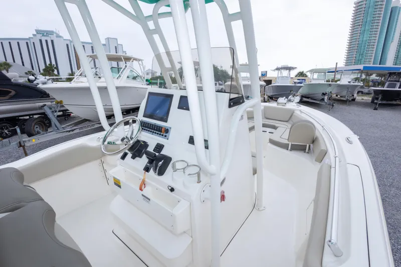 Slide: The Image of 2023 Key West 239 FS boat interior with steering console and seating area. - 29