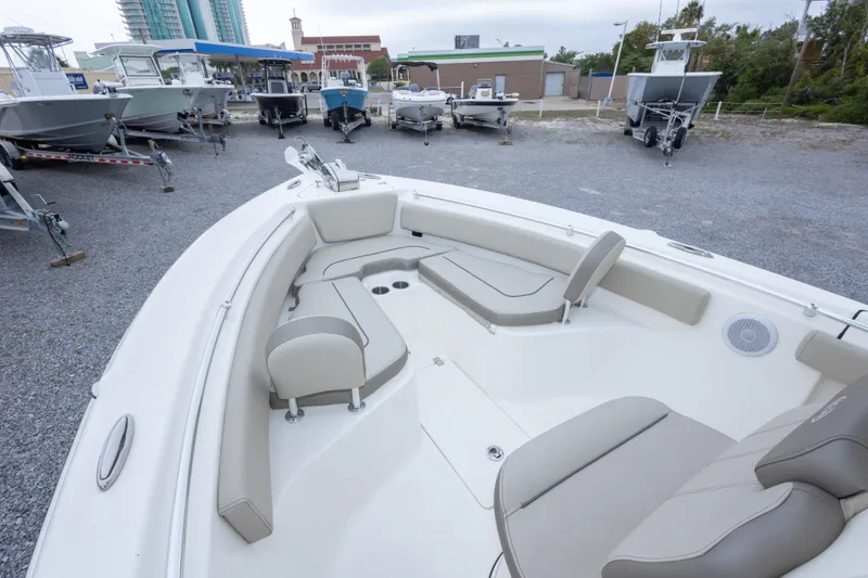 Slide: The Image of 2023 Key West 239 FS boat interior with cushioned seating in a marina setting. - 31