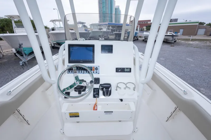 Slide: The Image of 2023 Key West 239 FS boat dashboard with steering wheel and navigation display. - 35