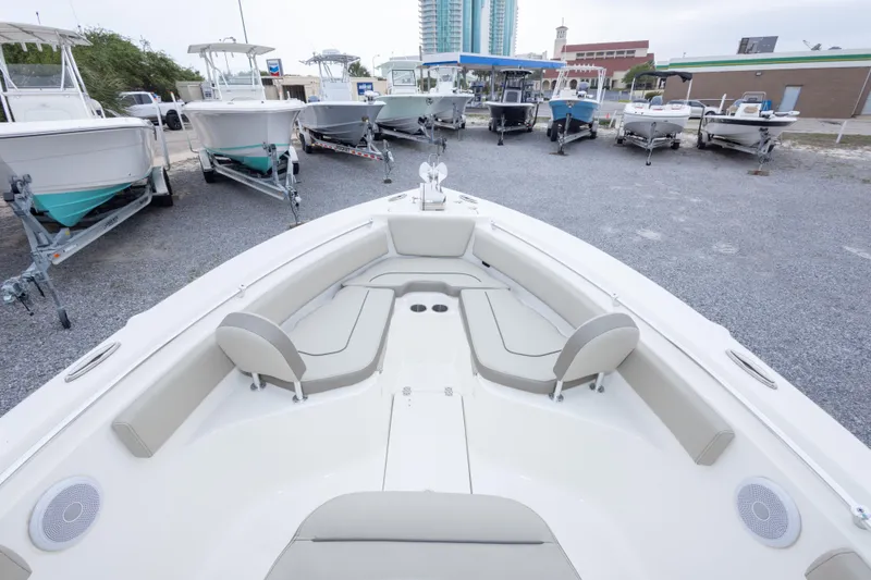 Slide: The Image of 2023 Key West 239 FS boat interior with seating, parked among other boats. - 36