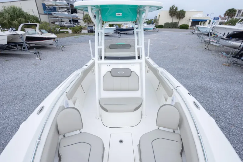 Slide: The Image of 2023 Key West 239 FS boat interior with seating, parked in a marina. - 38