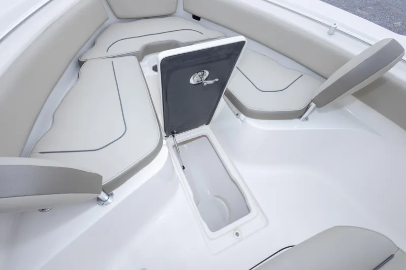 Slide: The Image of 2023 Key West 239 FS boat interior with open storage compartment and cushioned seating. - 39