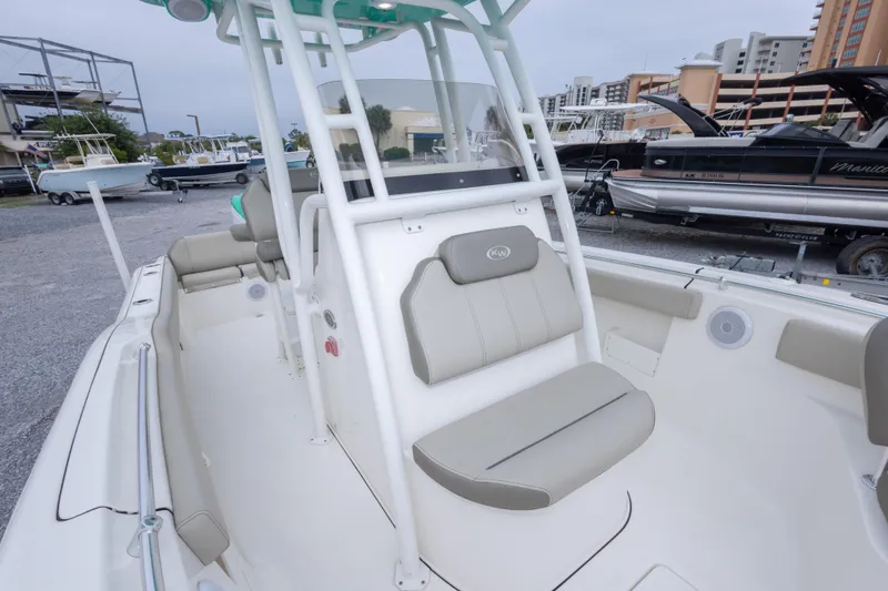 Slide: The Image of 2023 Key West 239 FS boat interior with seating and console, docked in a marina. - 41