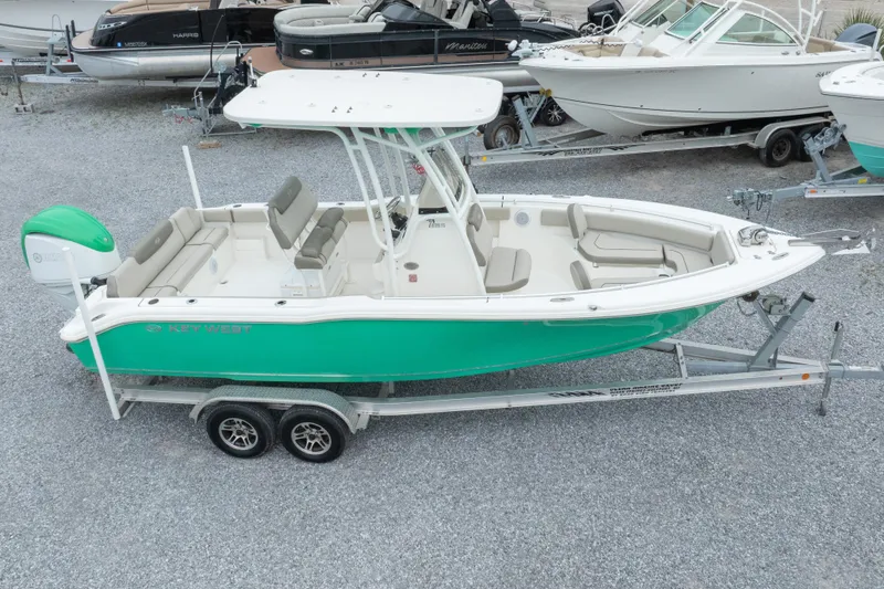 Slide: The Image of 2023 Key West 239 FS boat on trailer, vibrant green hull, spacious seating. - 9