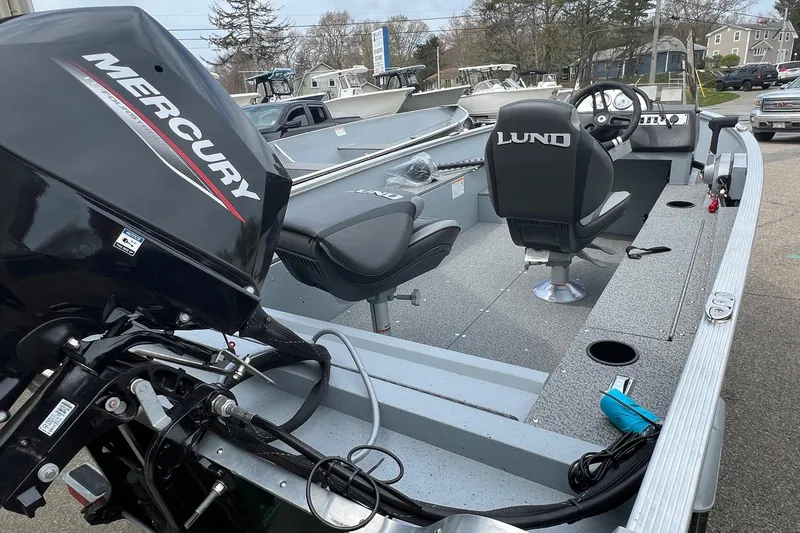 Slide: The Image of 2026 Lund 1400 Fury SS boat with Mercury engine, featuring spacious seating and modern design. - 12