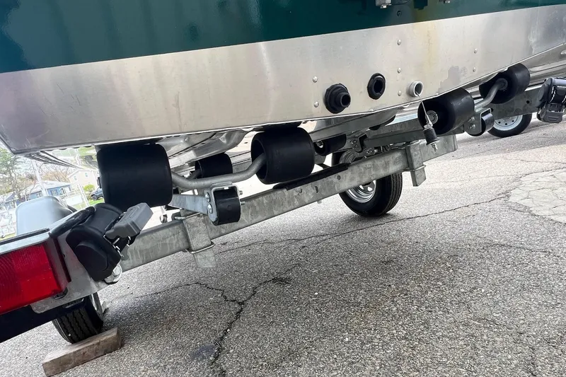 Slide: The Image of 2026 Lund 1400 Fury SS boat trailer with rollers on pavement. - 13