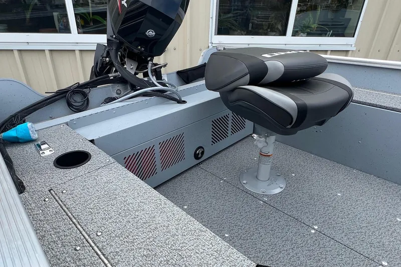 Slide: The Image of 2026 Lund 1400 Fury SS boat interior with seating and motor, showcasing modern design. - 20