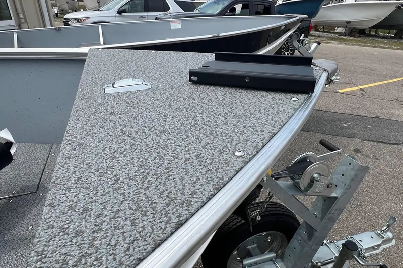 Slide: The Image of 2026 Lund 1400 Fury SS boat on trailer, showcasing bow and winch. - 21