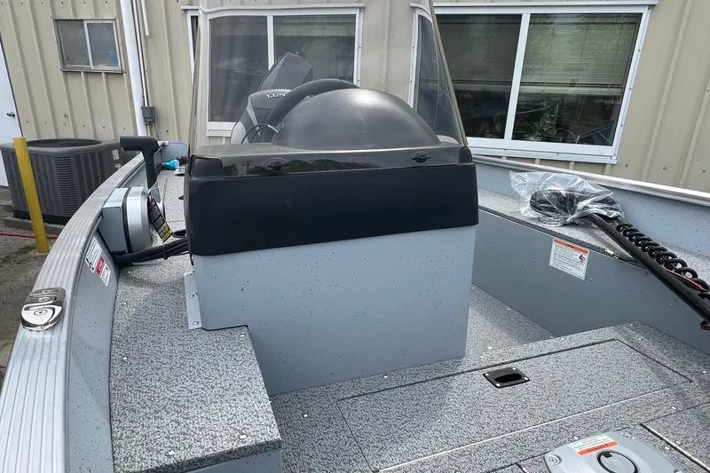 Slide: The Image of 2026 Lund 1400 Fury SS boat interior with steering console and seating. - 9