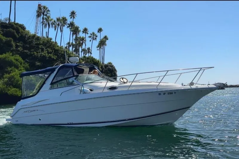 The Image of 2000 Monterey 302 Cruiser boat on water with palm trees in background. - 1