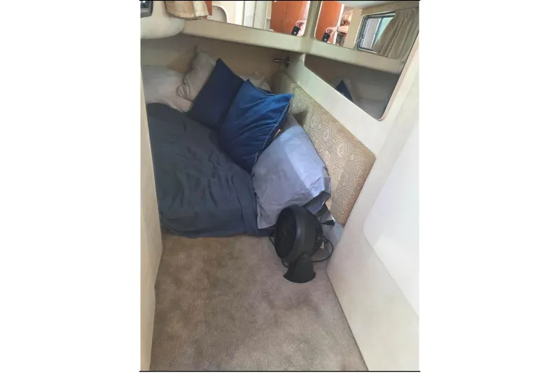 Slide: The Image of Cozy cabin interior of 2000 Monterey 302 Cruiser with pillows and fan. - 10
