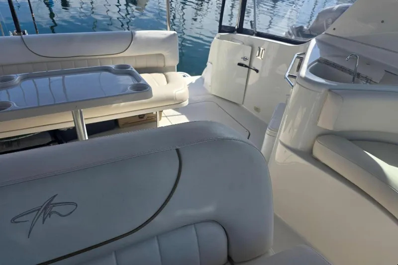 Slide: The Image of Interior of a 2000 Monterey 302 Cruiser boat with seating and table. - 12