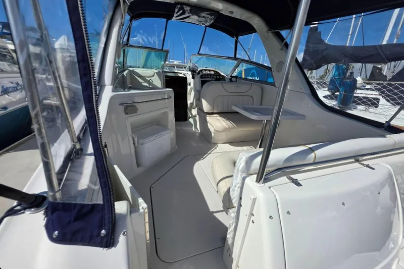 Slide: The Image of Interior view of a 2000 Monterey 302 Cruiser boat with seating and table. - 15