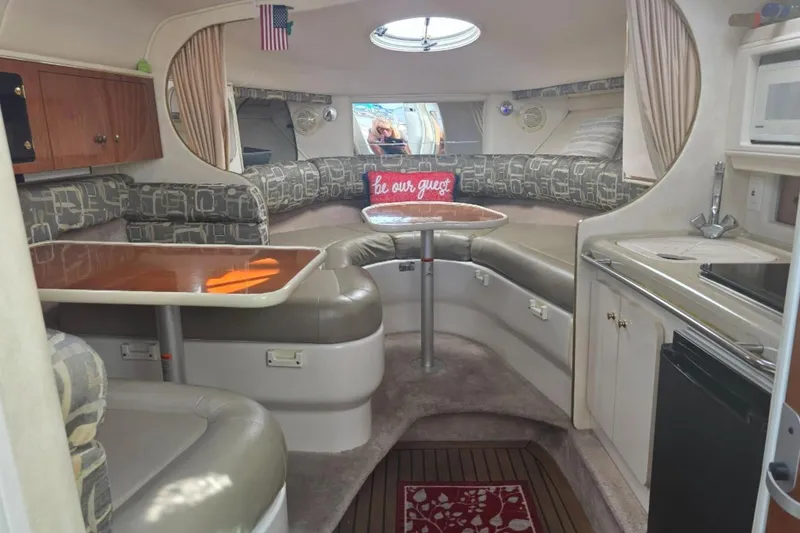 Slide: The Image of Interior of a 2000 Monterey 302 Cruiser with cozy seating and kitchenette. - 3