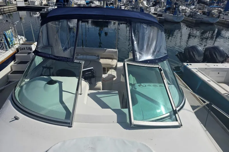 Slide: The Image of 2000 Monterey 302 Cruiser boat docked at marina with open windshield. - 4