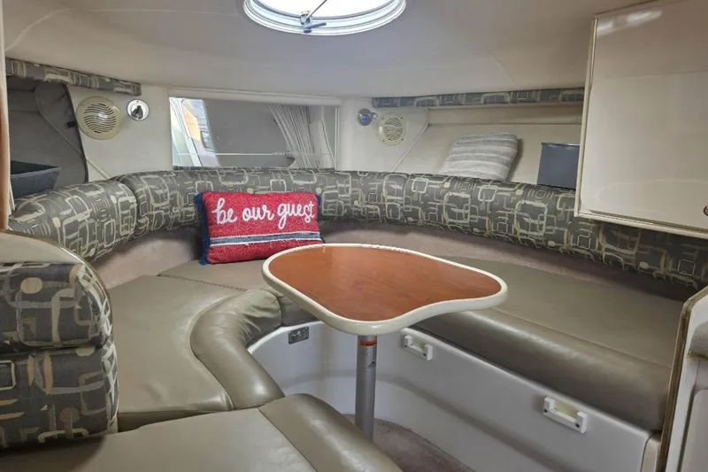 Slide: The Image of Interior of a 2000 Monterey 302 Cruiser with cozy seating and decorative pillows. - 5