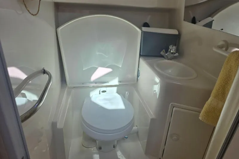 Slide: The Image of Bathroom interior of a 2000 Monterey 302 Cruiser boat, featuring toilet and sink. - 8